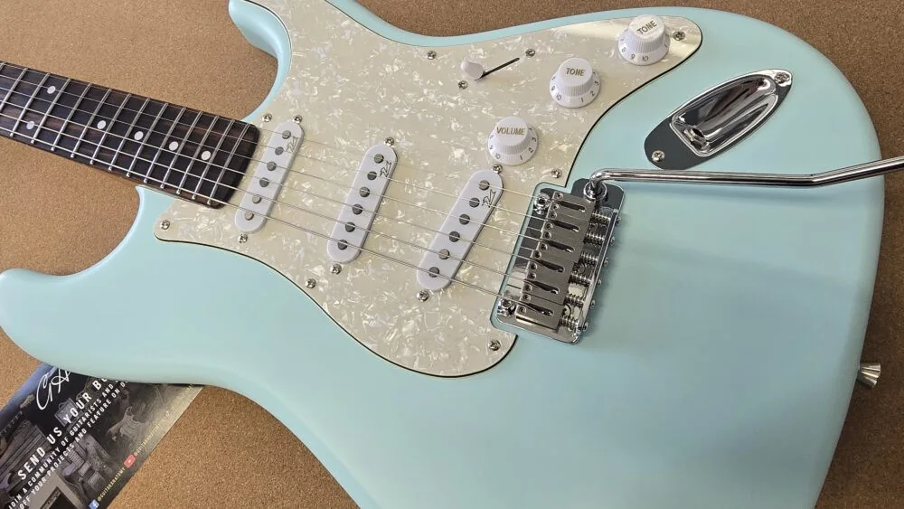 Close-up of an assembled seafoam S-style guitar body