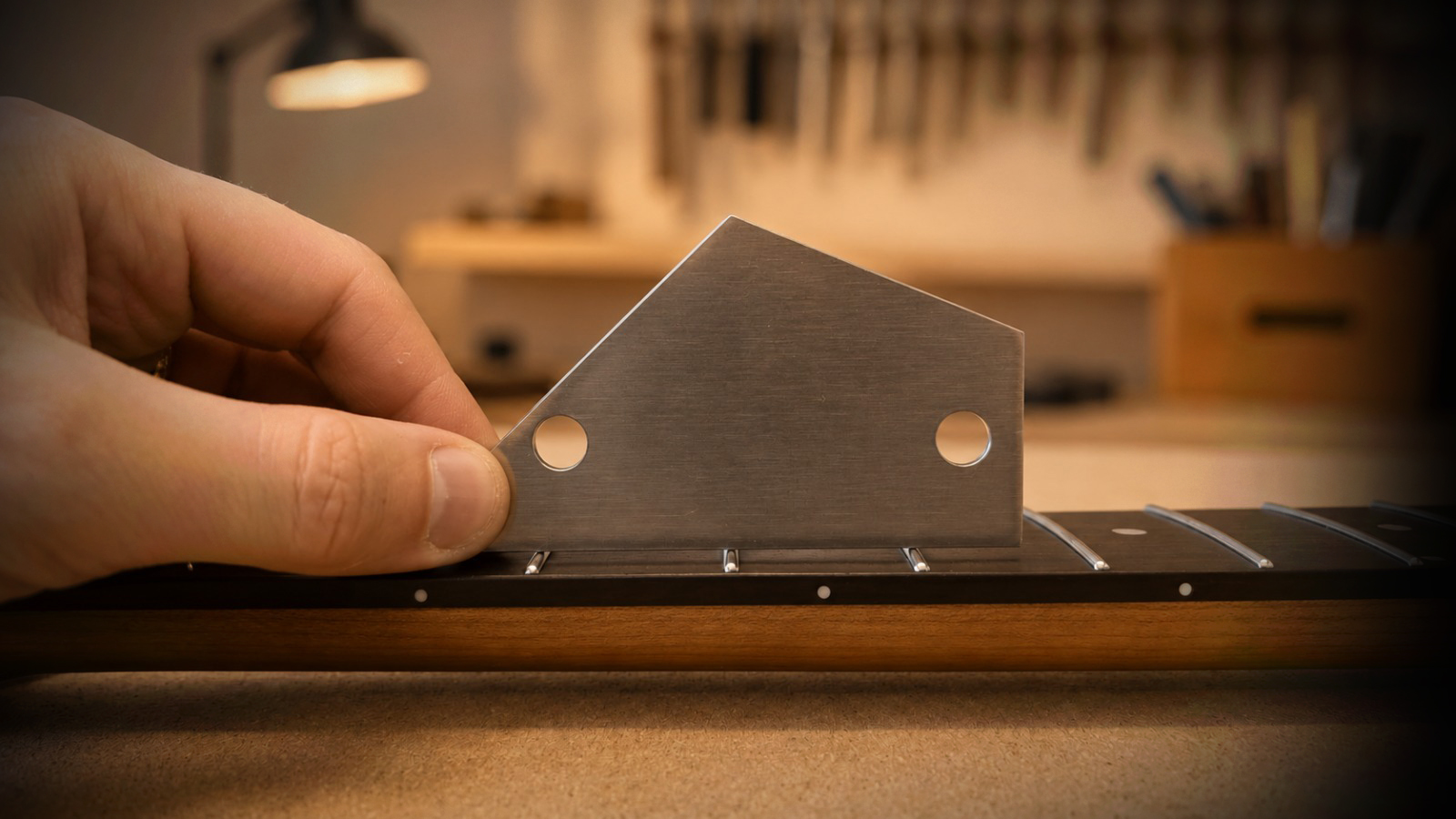 Guitar neck quality check in a warm workshop setting