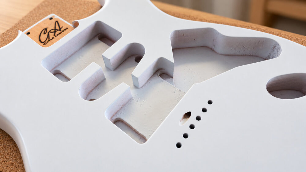 Close-up of guitar body pickup and control routing