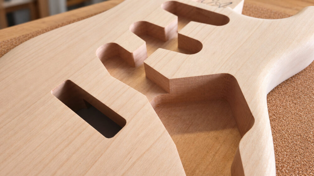 Close-up of guitar body pickup and control routing